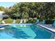 Community pool featuring lounge chairs and manicured hedges, creating a serene and inviting atmosphere at 564 Lakeside Dr # 564, Bradenton, FL 34210