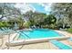 Relaxing community pool surrounded by verdant trees and a brick pool deck, perfect for summer relaxation at 564 Lakeside Dr # 564, Bradenton, FL 34210