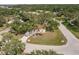 A captivating home surrounded by mature trees, with a long driveway and lush green lawn at 5902 22Nd Avenue E Dr, Palmetto, FL 34221