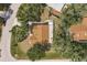 Overhead view of home featuring a brown roof with mature trees in a peaceful neighborhood at 5902 22Nd Avenue E Dr, Palmetto, FL 34221