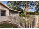 Charming backyard with a picket fence, lush greenery, and mature shade trees at 5902 22Nd Avenue E Dr, Palmetto, FL 34221