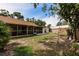 Picturesque backyard showcasing the screened lanai, storage shed and mature trees at 5902 22Nd Avenue E Dr, Palmetto, FL 34221