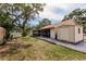 Spacious backyard featuring a screened-in porch, shed and mature trees for shade at 5902 22Nd Avenue E Dr, Palmetto, FL 34221