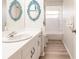 Bathroom showcasing a vanity, decorative mirrors and shower-tub combo, all in clean, neutral tones at 5902 22Nd Avenue E Dr, Palmetto, FL 34221