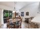 Cozy dining area adjacent to the kitchen, featuring a chandelier and backyard view at 5902 22Nd Avenue E Dr, Palmetto, FL 34221