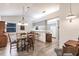 Cozy dining room adjacent to kitchen featuring a wooden table, seating for four, and modern chandelier at 5902 22Nd Avenue E Dr, Palmetto, FL 34221