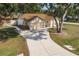 Aerial view of a charming single-Gathering home, featuring a well-manicured front yard and long driveway at 5902 22Nd Avenue E Dr, Palmetto, FL 34221