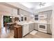 Well-lit kitchen with white appliances, gray cabinets, and adjacent dining area at 5902 22Nd Avenue E Dr, Palmetto, FL 34221