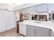 Functional kitchen with white countertops, gray cabinets, and wood-look flooring at 5902 22Nd Avenue E Dr, Palmetto, FL 34221