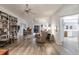 Spacious living room featuring wood-look tile flooring, a built-in bookcase, and a comfortable seating area at 5902 22Nd Avenue E Dr, Palmetto, FL 34221