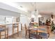 Open floor plan dining and kitchen with wood floors and view to living area at 5902 22Nd Avenue E Dr, Palmetto, FL 34221