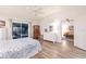Spacious main bedroom with neutral walls, ceiling fan, and a sliding glass door leading to a patio at 5902 22Nd Avenue E Dr, Palmetto, FL 34221