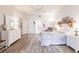 Light-filled main bedroom with wood-look floors, white trim, a ceiling fan, and ensuite bathroom access at 5902 22Nd Avenue E Dr, Palmetto, FL 34221