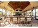 Spacious outdoor bar area with plenty of seating, televisions and ceiling fans at 5923 Snowy Egret Dr, Sarasota, FL 34238
