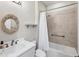Updated bathroom with white vanity, decorative mirror, shower and bathtub combo, and tiled walls at 5923 Snowy Egret Dr, Sarasota, FL 34238