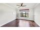 Bright bedroom features hardwood floors, crown molding, ceiling fan, and a large window at 5923 Snowy Egret Dr, Sarasota, FL 34238