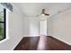This bedroom features hardwood floors, a ceiling fan, and en-suite bathroom access at 5923 Snowy Egret Dr, Sarasota, FL 34238