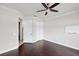 Bedroom with hardwood floors, ceiling fan, closet, and door to the bathroom at 5923 Snowy Egret Dr, Sarasota, FL 34238