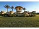 The Sandhill Preserve entrance is marked by a decorative structure, manicured landscaping, and swaying palms at 5923 Snowy Egret Dr, Sarasota, FL 34238