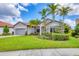 Well-maintained home with a lush front lawn and mature palm trees at 5923 Snowy Egret Dr, Sarasota, FL 34238