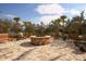 Outdoor fire pit area with built-in stone firepit and lots of seating at 5923 Snowy Egret Dr, Sarasota, FL 34238