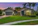 Charming single-story home with lush lawn, mature landscaping, and a terracotta tile roof at 5923 Snowy Egret Dr, Sarasota, FL 34238