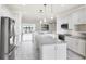 Open kitchen with island, stainless steel appliances and sightlines to other rooms at 5923 Snowy Egret Dr, Sarasota, FL 34238