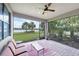 Spacious lanai with comfortable seating and beautiful views of the lake and palm trees at 5923 Snowy Egret Dr, Sarasota, FL 34238