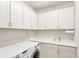 Laundry room featuring LG washer and dryer, white cabinets, countertop, and sink at 5923 Snowy Egret Dr, Sarasota, FL 34238