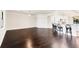 Large living room with hardwood floors and adjacent breakfast bar with seating at 5923 Snowy Egret Dr, Sarasota, FL 34238