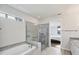Bright and clean main bathroom showcasing a glass shower with soaking tub and tile flooring at 5923 Snowy Egret Dr, Sarasota, FL 34238