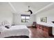 Main bedroom showcasing hardwood floors, dresser, and water view from the window at 5923 Snowy Egret Dr, Sarasota, FL 34238