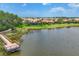 Scenic view of a pond, walkway, and surrounding homes with lush greenery and a beautiful skyline at 5923 Snowy Egret Dr, Sarasota, FL 34238