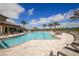 Sparkling community pool with lounge chairs and palm trees at 5923 Snowy Egret Dr, Sarasota, FL 34238