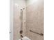 Close-up of tile shower with safety bar and updated shower head fixture at 5923 Snowy Egret Dr, Sarasota, FL 34238