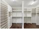Large walk-in closet features custom shelves, drawers, and ample storage space at 5923 Snowy Egret Dr, Sarasota, FL 34238