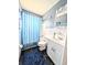 Cozy bathroom features a vanity, toilet and shower with a blue shower curtain at 5951 Todd St # D37, Bradenton, FL 34207