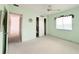 Open view of a bedroom with mint walls, carpeting, and closet at 5951 Todd St # D37, Bradenton, FL 34207