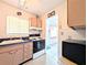 Kitchen with oven range, sink, and window for lots of light at 5951 Todd St # D37, Bradenton, FL 34207