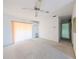 Spacious living room with white walls, carpeted area, ceiling fan, and lots of light from a sliding door at 5951 Todd St # D37, Bradenton, FL 34207
