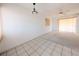 Empty living room with tiled floor, white walls, and a carpeted area at 5951 Todd St # D37, Bradenton, FL 34207