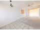 Empty living room with tiled floor, white walls, and a carpeted area at 5951 Todd St # D37, Bradenton, FL 34207