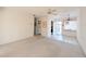 Living room with white walls, tiled floors, carpeted area, ceiling fan, and access to other rooms at 5951 Todd St # D37, Bradenton, FL 34207
