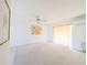 Bright living room features neutral carpet, ceiling fan, and natural light from windows at 5951 Todd St # D37, Bradenton, FL 34207