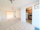 Living room features tiled floor, a carpeted area, a ceiling fan, and an adjacent doorway into the kitchen at 5951 Todd St # D37, Bradenton, FL 34207