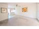 Bright living room features neutral carpet, ceiling fan, and natural light from the adjacent room at 5951 Todd St # D37, Bradenton, FL 34207