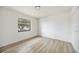 Bright bedroom features modern wood-look floors, a large window, and closet space at 624 Fort Duquesna Dr, Sun City Center, FL 33573
