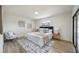 Bedroom featuring a comfortable bed, stylish decor, wood floors, and sliding glass doors to the exterior at 624 Fort Duquesna Dr, Sun City Center, FL 33573