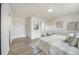 Bright bedroom featuring a cozy bed, stylish decor, wood floors, a chair, and modern decor at 624 Fort Duquesna Dr, Sun City Center, FL 33573