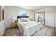 Bright primary bedroom boasts wood floors, ensuite bath, decorative area rug and a large picture window at 624 Fort Duquesna Dr, Sun City Center, FL 33573